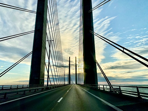 Aerial view of the Russian bridge from the mainland to the Russian island in the East Sea. The longest longest span. Summer dawn on the sea. Guys in the colors of the Russian flag. Vladivostok, Russia