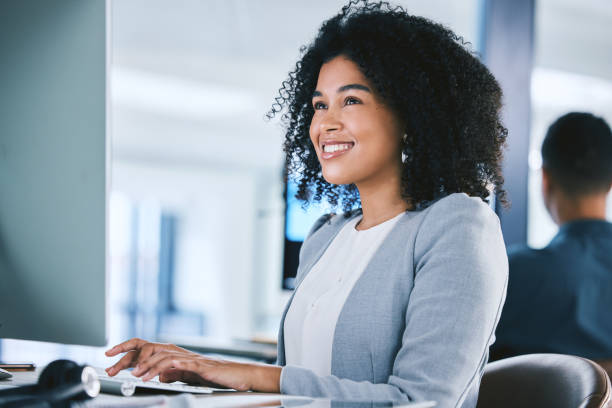 istock One happy young mixed race call centre telemarketing agent talking on a headset while working on a computer in an office. Confident friendly female consultant operating helpdesk for customer service and sales support 1400848460