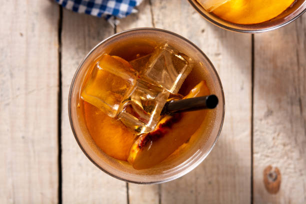 istock Glass of peach tea with ice cubes 1400851189