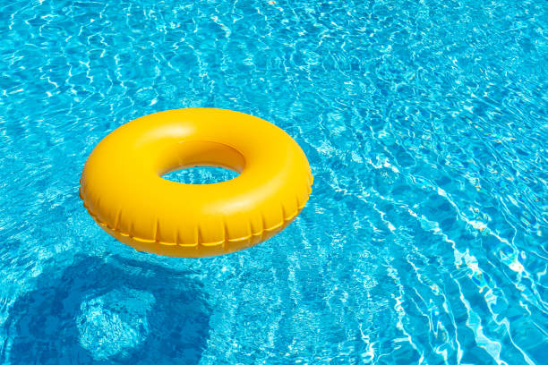 istock Yellow ring floating in blue swimming pool. Inflatable ring, rest concept 1400852550