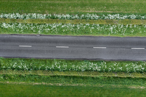 High angle view from a drone of an empty country road in Scotland on a summer morning