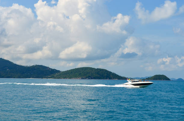 istock speed boat in the sea, blue sky and clouds 1400853588