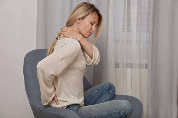 Woman suffering from back and neck pain. Chiropractic, Physiotherapy concept stock photo