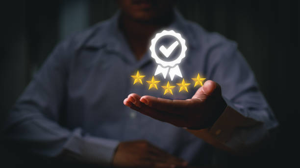 Businessman holding and showing the best quality assurance with golden five stars for guarantee product and ISO service concept. Businessman holding and showing the best quality assurance with golden five stars for guarantee product and ISO service concept. mid adult men stock pictures, royalty-free photos & images