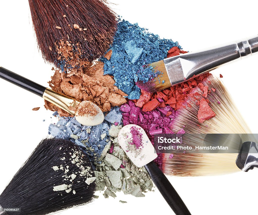 Composition with makeup brushes and broken multicolor eye shadow Composition with makeup brushes and broken multicolor eye shadows on white Artist's Palette Stock Photo