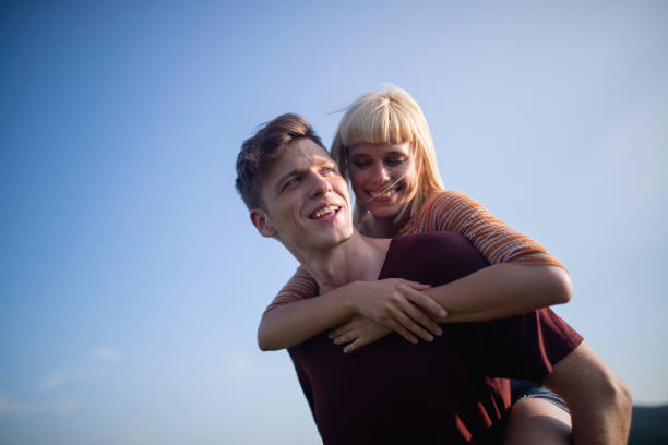 A young woman and a young man enjoy nature.
