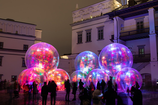 Vilnius, Lithuania - January 26, 2022: Light installation at the Palace of Grand Dukes with inflated bubbles illuminated by various colors during Vilnius Light Festival.