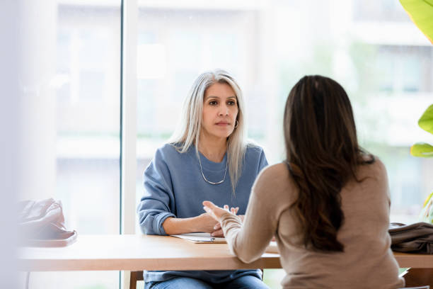 istock Serious female therapist listens to unrecognizable female client 1400859821