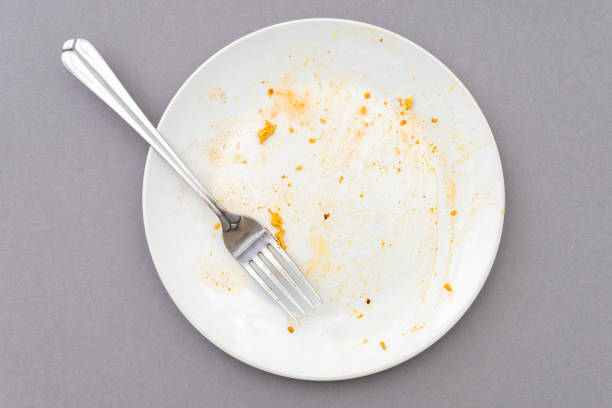 istock Top view of white plate, fork and food leftover 1400860196