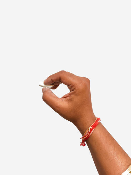 istock Hand holding a chalk to write on a white cream background and free text space 1400861940