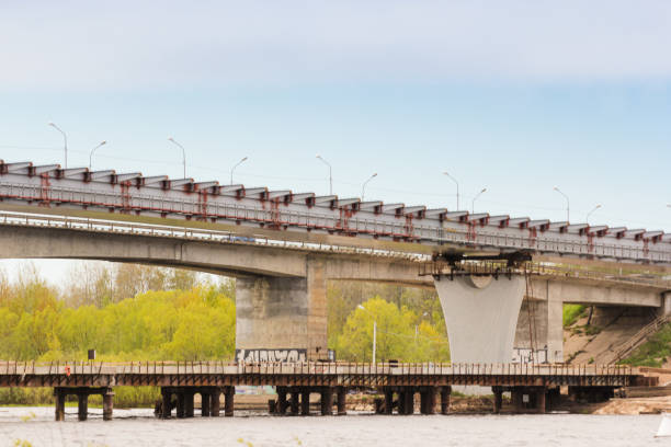 Erection of metal structures of the new bridge next to the old one. Kirishi, Russia - 24 May, 2022.
Construction of a road bridge in Kirishi across the Volkhov River. song title stock pictures, royalty-free photos & images
