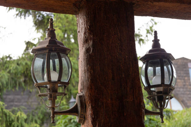 istock Old style metallic lanterns attached to brown wooden pillar 1400864232