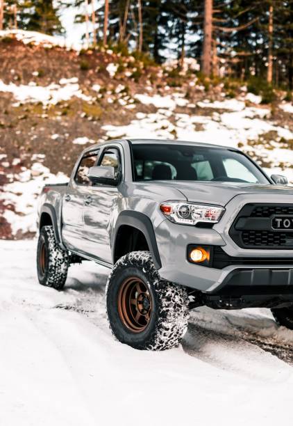 North Bend, WA, USA6/1/2022Toyota Tacoma driving in the snow with a hill in the background