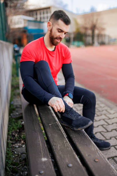 istock Man tying his shoelace outdoors 1400865483