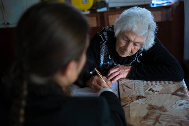 istock Insurance agent discussing with senior lady at her home. 1400868941