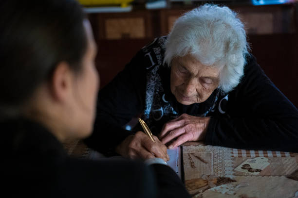 istock Insurance agent discussing with senior lady at her home. 1400869022
