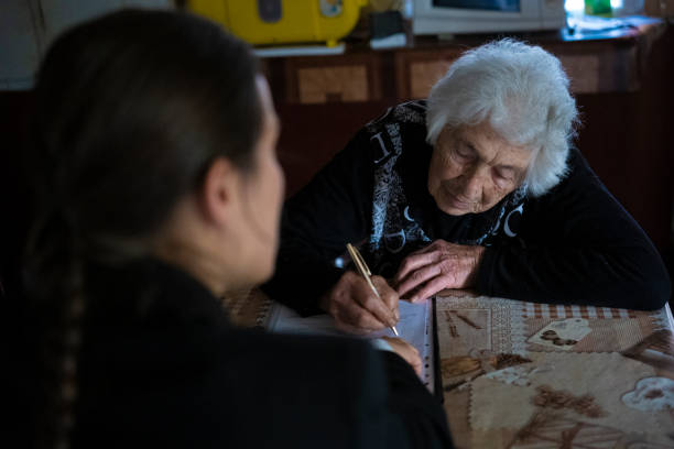 istock Insurance agent discussing with senior lady at her home. 1400869026