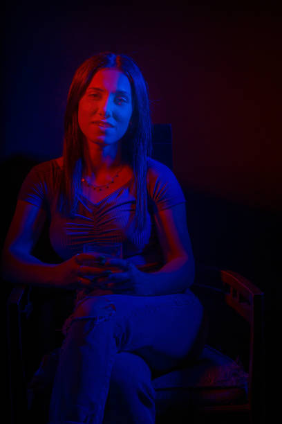 Woman with red and dark blue gel lighting. Woman with color magic studio flash filters.