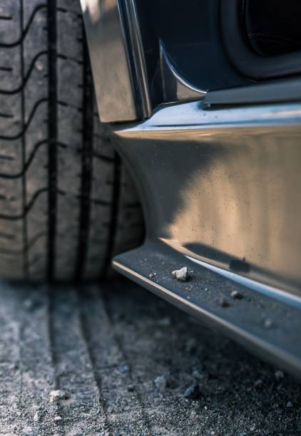 istock Grey car with rocks on the side skirt 1400870788