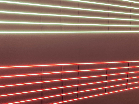 neon stripes, illumination. stripes of red and white on a black ceiling. bright neon, decorative panels, electrical design.