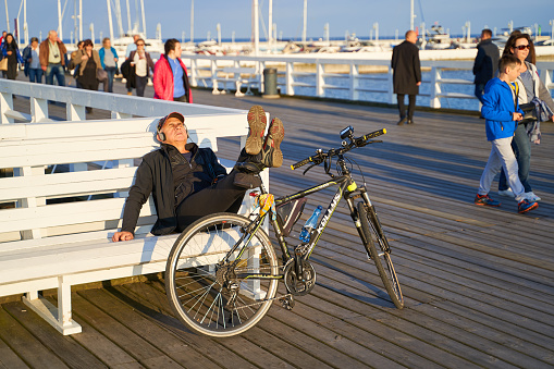 Man relaxing with his bicycle on the Sopot Pier