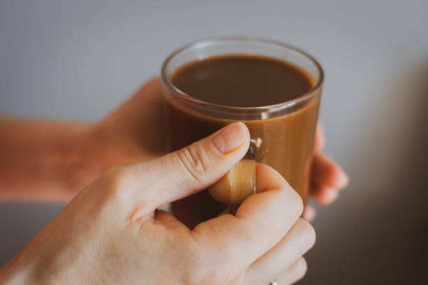 Girl holding coffee cup. Hands holding cup of morning coffee. Latte in cafe. Cappuccino cup. Espresso with milk. Hot drinks. Relax with coffee. Breakfast concept.
