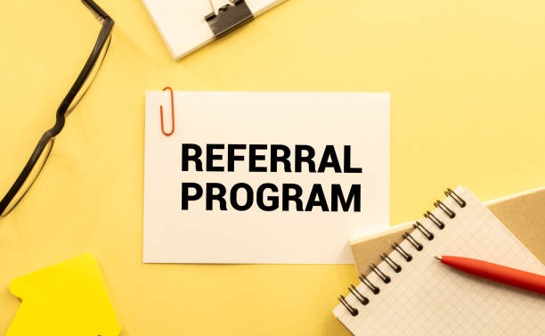 istock Referral Program open notepad on desktop near white keyboard and yellow stickers and glasses 1400880499