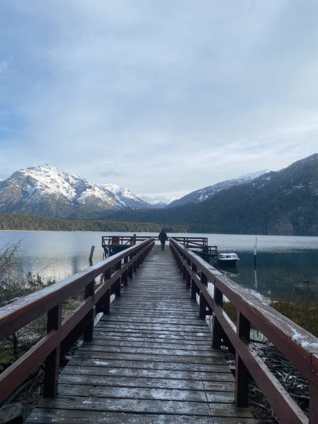 istock Man walks on a over a lake towards the mountains 1400881268