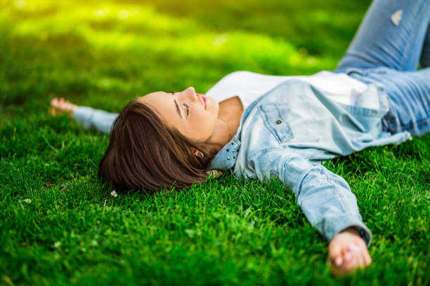 istock Tranquil young woman sleeping outdoors in nature. 1400881346
