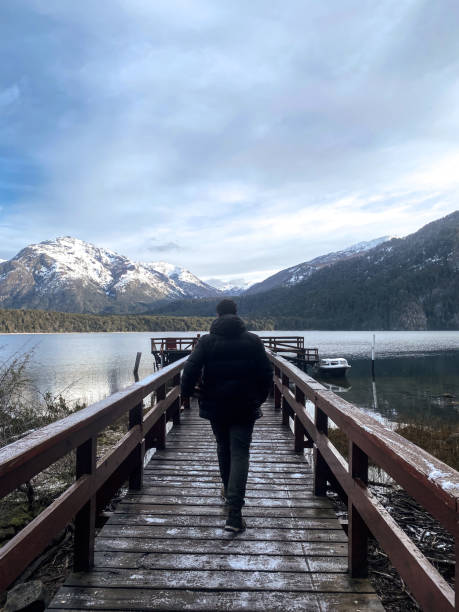 istock Man walks on a over a lake towards the mountains 1400881541
