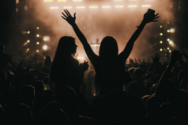 two woman in the crowd at a music festival - bar women silhouette child imagens e fotografias de stock