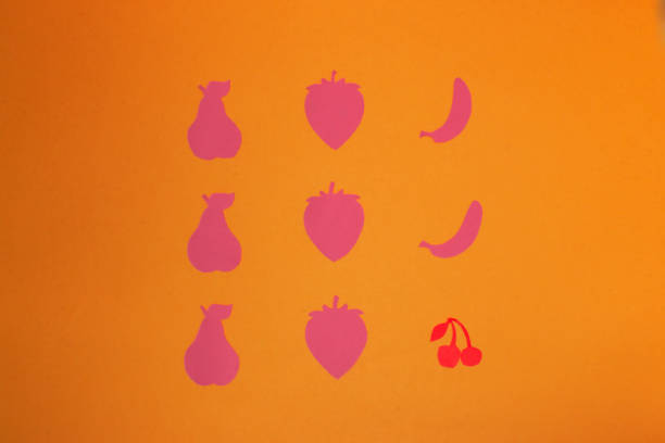 istock pattern with 9 fruits of pink color and one red, break the pattern, creative vitamin background 1400882718