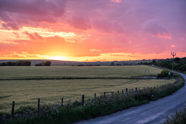 istock Farm field in sunset colours and cloudy skies 1400890049