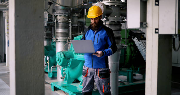 istock A millennial environmental engineer working on a laptop while standing in a heating plant. 1400893339