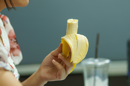 Women Eating banana for breakfast