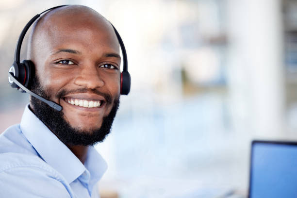 istock Black sales agents wearing a headset while working in a call centre. Helping with customer care and services 1400903829