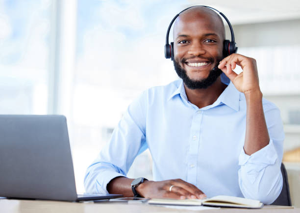 istock Black sales agents wearing a headset while working in a call centre. Helping with customer care and services 1400903980