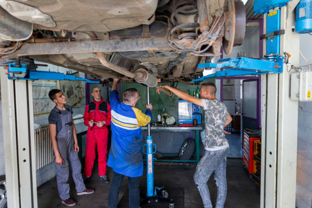 istock Male tutor with students on auto mechanic apprenticeship course at college 1400905976