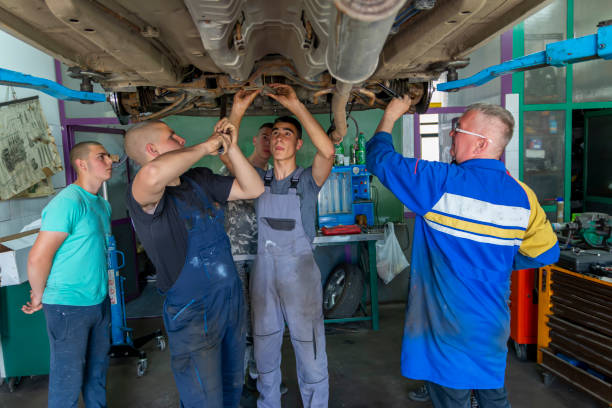 istock Male tutor with students on auto mechanic apprenticeship course at college 1400907286