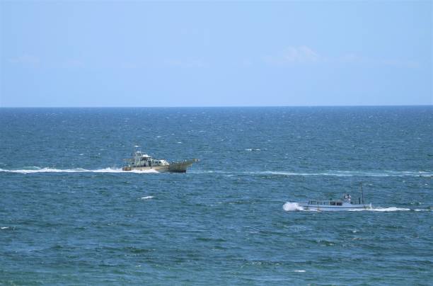 istock Fishing boat on the shining water 1400907366