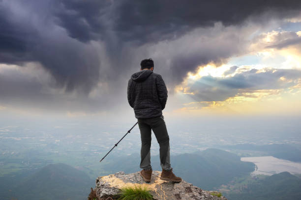 istock Hiker with backpack relaxing hiking holiday Hiker with backpack and trekking pole. 1400917159