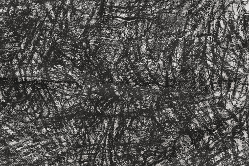 black charcoal doodles on gray paper background texture