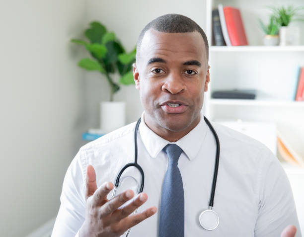 Doctor gesturing his hand while he explains treatment stock photo