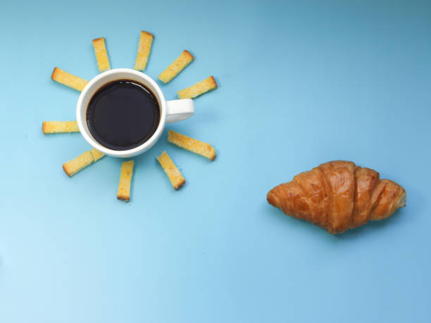 istock Creative breakfast idea, sunrise morning blue sky with cloud meal, hot black coffee, crispy bread butter sugar and croissant. 1400923706