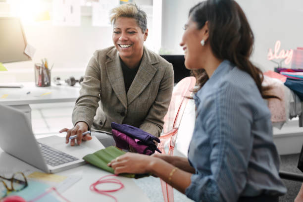 istock Multiracial Asian women work together using laptop computer in bright modern creative fashion design office interior 1400928341