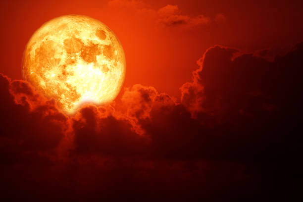istock Full pink moon and white silhouette cloud in the night sky 1400929149