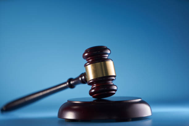 istock gavel hammer against blue background 1400931950