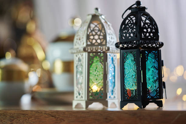 istock Ornamental Arabic lantern with burning candle glowing  and  beautiful tea set  as background 1400932761