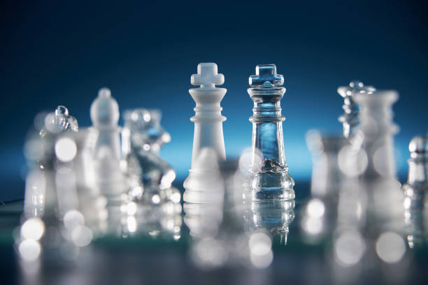 istock glass chess on the chess board against blue background 1400932857