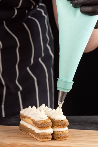 istock Making dessert tiramisu cake on a dark background 1400936399
